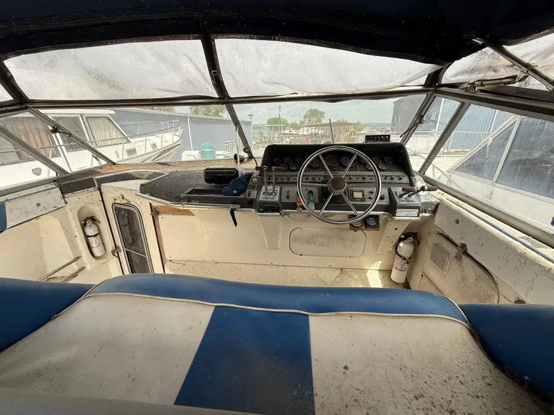 Slide: The Image of Cockpit of a 1986 Cruisers 337 boat with steering wheel and control panel. - 9