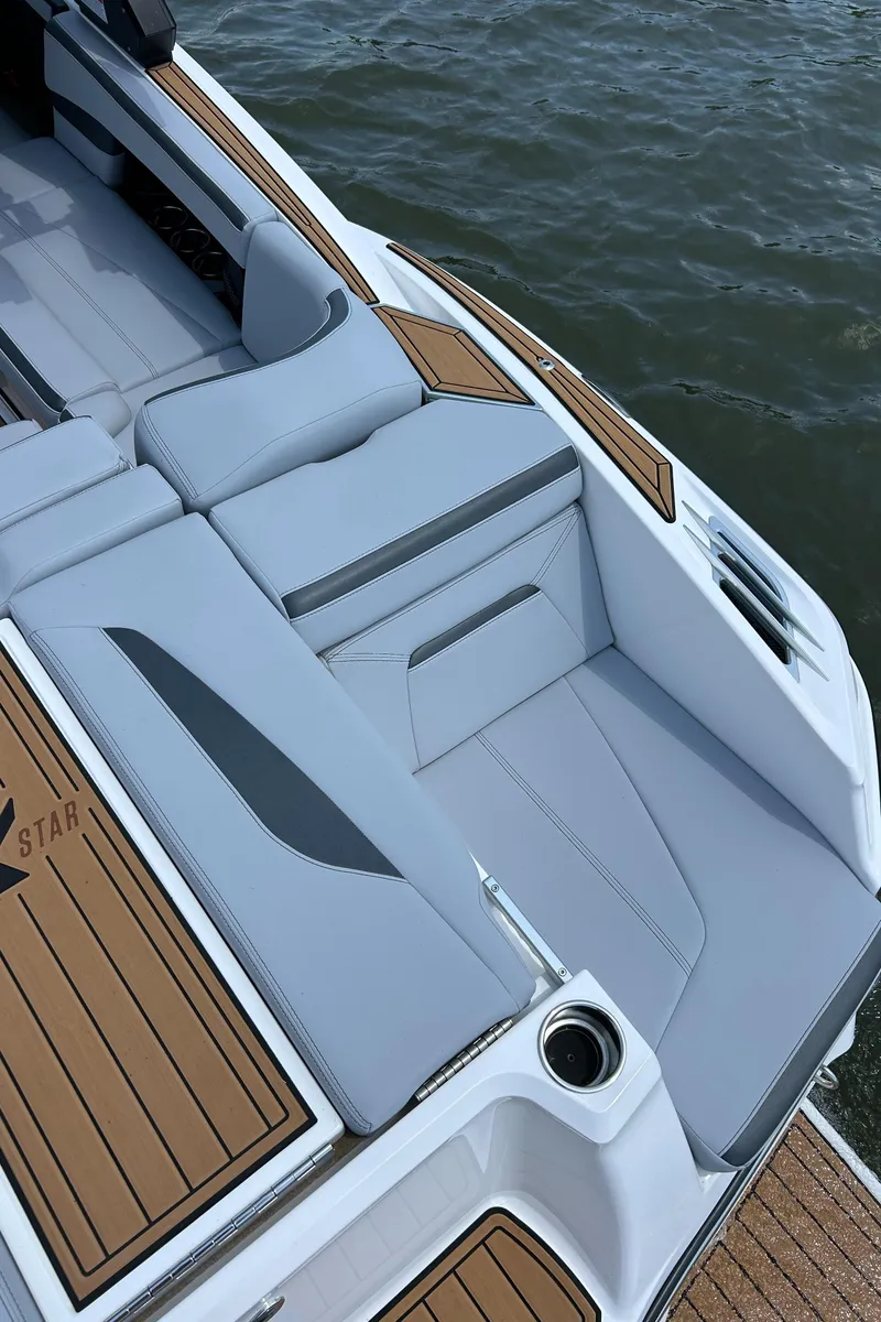 Slide: The Image of 2024 MasterCraft XStar S boat with sleek seating and teak accents on the water. - 10