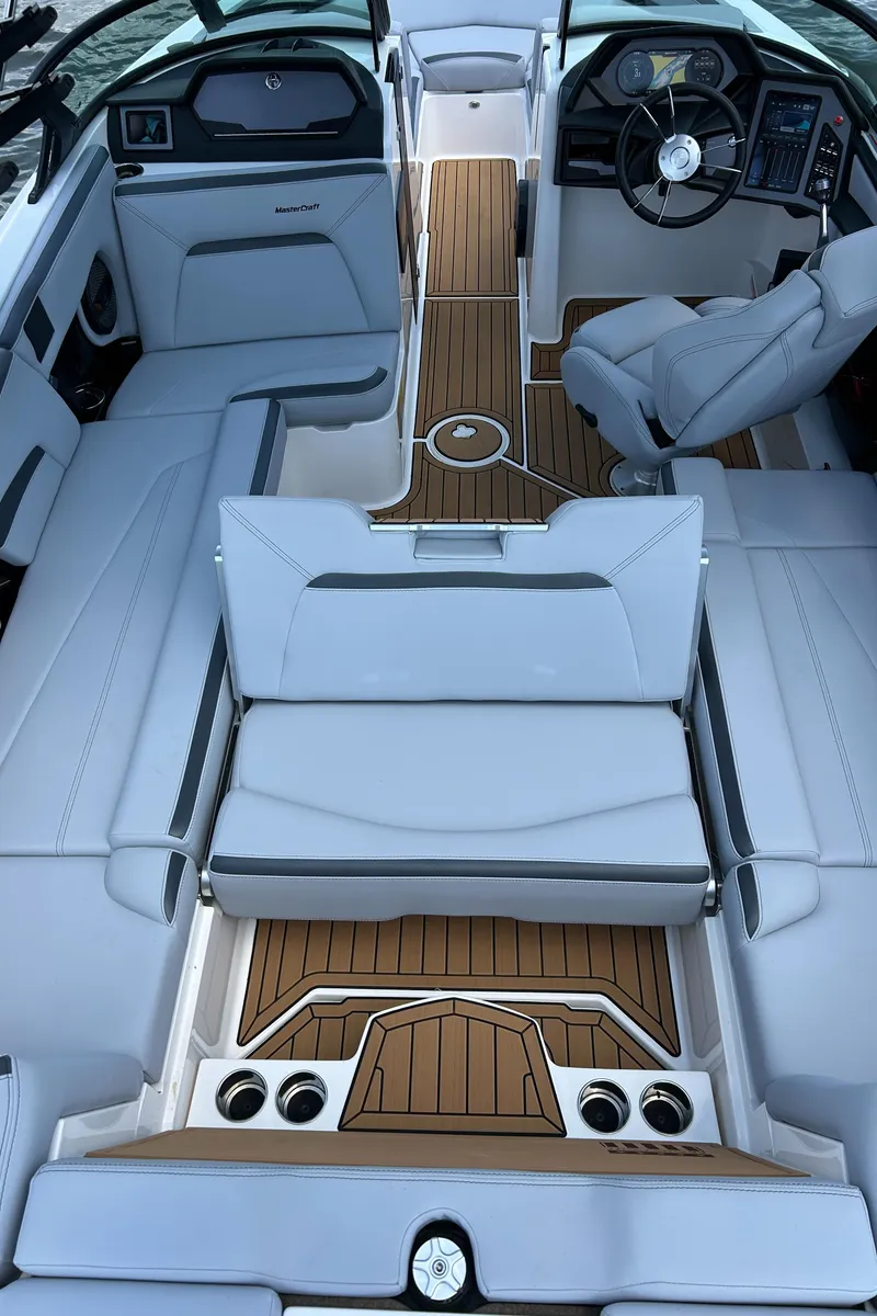 Slide: The Image of 2024 MasterCraft XStar S interior with sleek seating and modern dashboard design. - 11
