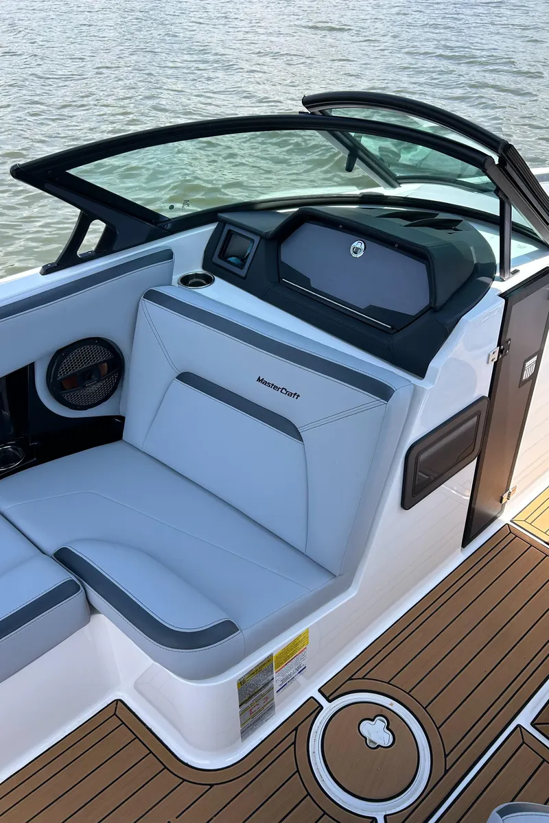 Slide: The Image of 2024 MasterCraft XStar S boat interior with sleek seating and modern dashboard design. - 5