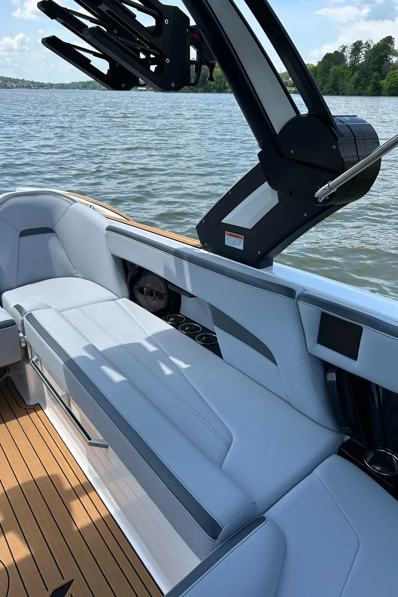 Slide: The Image of 2024 MasterCraft XStar S boat interior with sleek seating and lake view. - 6
