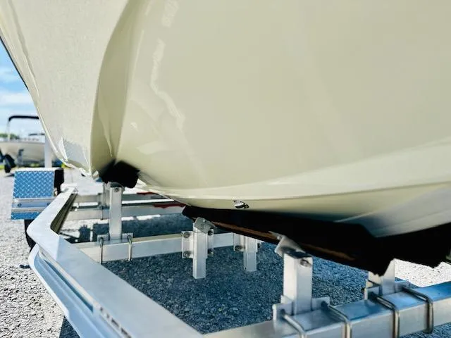 Slide: The Image of 1986 Boston Whaler 150 Sport boat on trailer, close-up view of hull and support. - 12