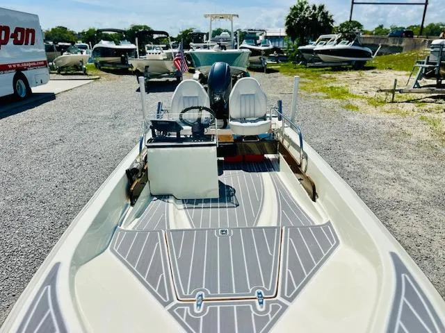 Slide: The Image of 1986 Boston Whaler 150 Sport boat with modern interior, parked in a marina. - 14