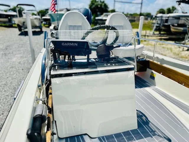 Slide: The Image of 1986 Boston Whaler 150 Sport boat interior with Garmin navigation system and steering wheel. - 15