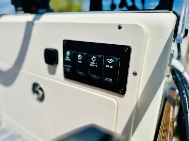 Slide: The Image of Control panel of a 1986 Boston Whaler 150 Sport boat with switches and buttons. - 17