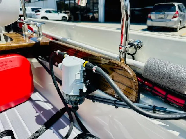 Slide: The Image of 1986 Boston Whaler 150 Sport interior with fuel tank and wiring details. - 19