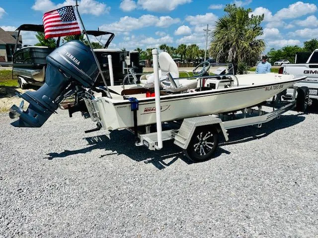 Slide: The Image of 1986 Boston Whaler 150 Sport boat with Yamaha motor on trailer, American flag displayed. - 2