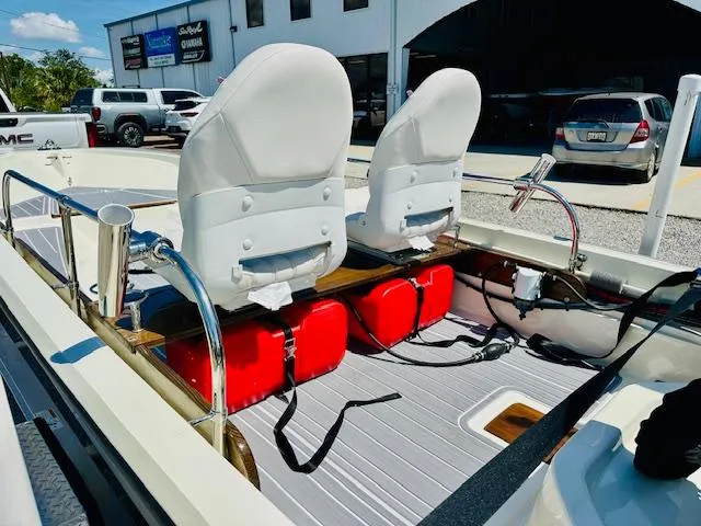 Slide: The Image of 1986 Boston Whaler 150 Sport interior with white seats and red fuel tanks. - 20