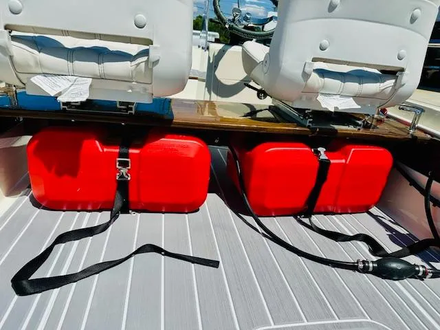 Slide: The Image of 1986 Boston Whaler 150 Sport boat interior with red fuel tanks and white seats. - 21