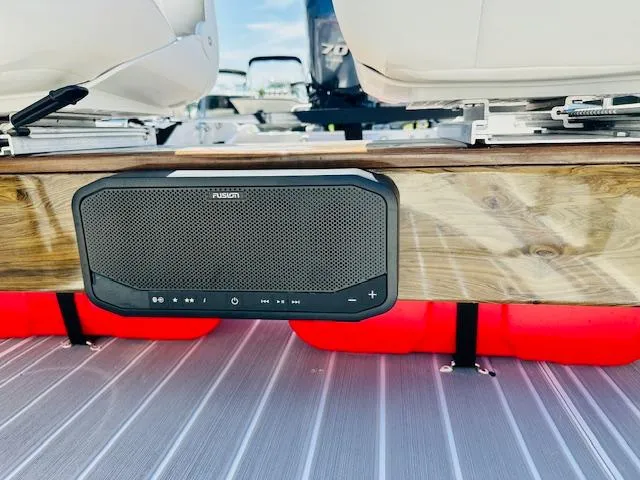 Slide: The Image of 1986 Boston Whaler 150 Sport with Fusion speaker mounted on wooden panel. - 24