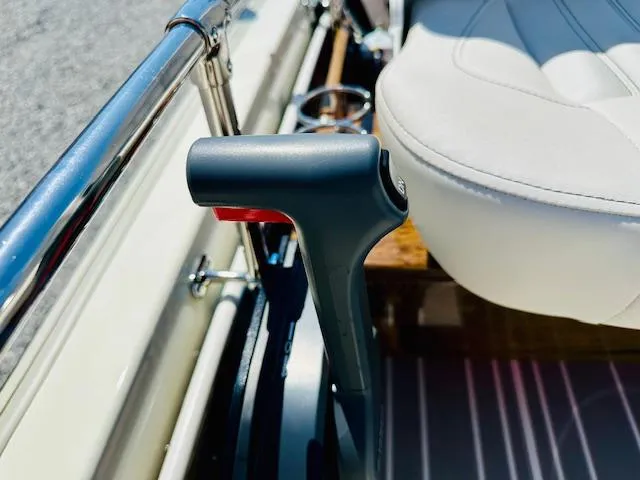 Slide: The Image of 1986 Boston Whaler 150 Sport boat interior with throttle control and white seat. - 26