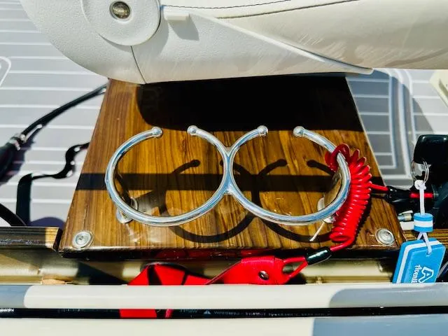 Slide: The Image of 1986 Boston Whaler 150 Sport boat interior with cup holders and safety lanyard. - 30