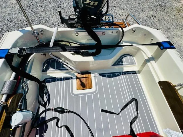 Slide: The Image of 1986 Boston Whaler 150 Sport boat interior with Yamaha motor, featuring striped flooring. - 32