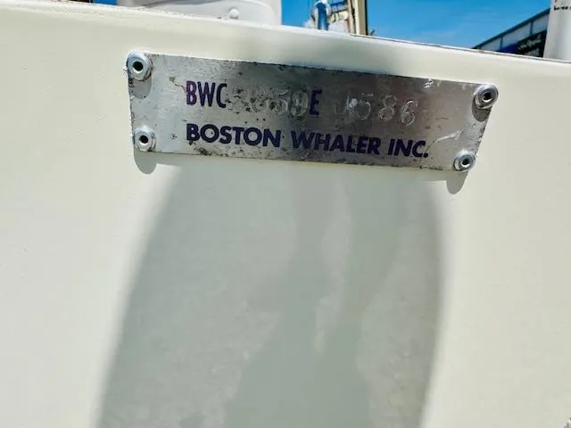 Slide: The Image of Boston Whaler 150 Sport 1986 nameplate on boat hull, showcasing model and year. - 34