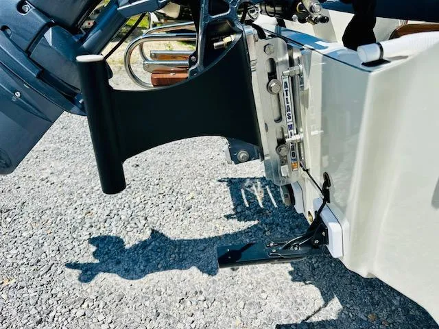 Slide: The Image of 1986 Boston Whaler 150 Sport boat engine detail on gravel surface. - 4