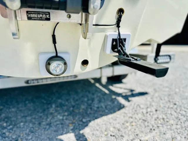 Slide: The Image of 1986 Boston Whaler 150 Sport boat transom with mounted accessories and trailer. - 7