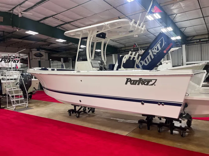 The Image of 2025 Parker 2600 Center Console boat displayed indoors on red carpet. - 0