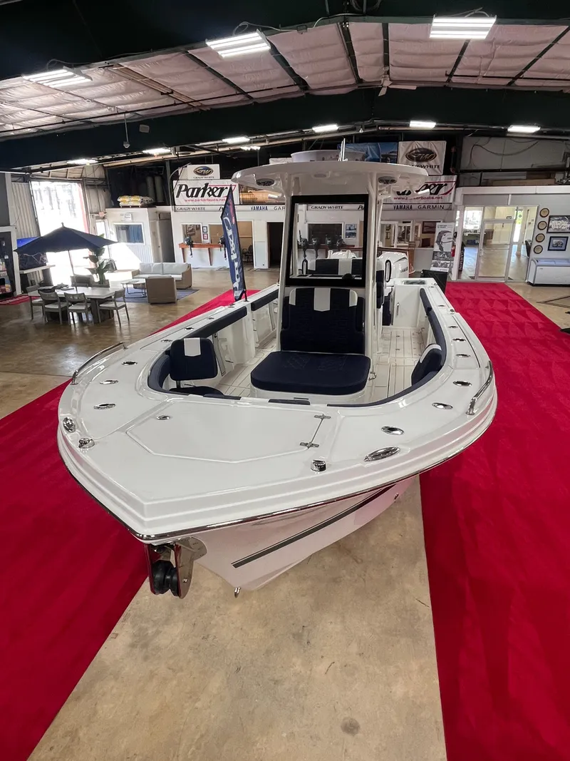 Slide: The Image of 2025 Parker 2600 Center Console boat displayed indoors on a red carpet. - 2