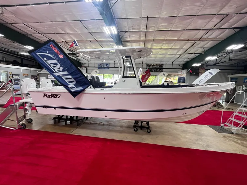 Slide: The Image of 2025 Parker 2600 Center Console boat displayed indoors on red carpet. - 3