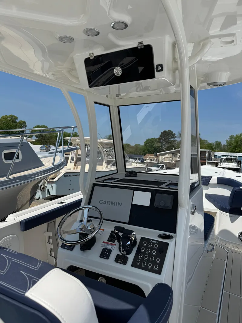 Slide: The Image of 2025 Parker 2600 Center Console boat interior with modern controls and Garmin navigation system. - 4