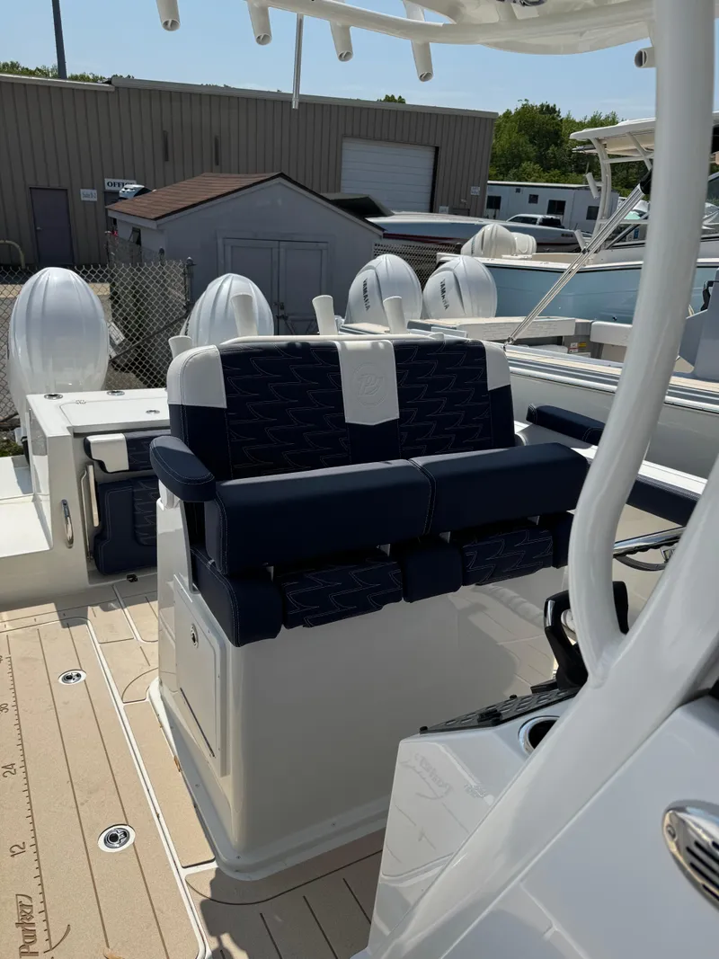 Slide: The Image of 2025 Parker 2600 Center Console boat with navy seating and dual outboard motors. - 6