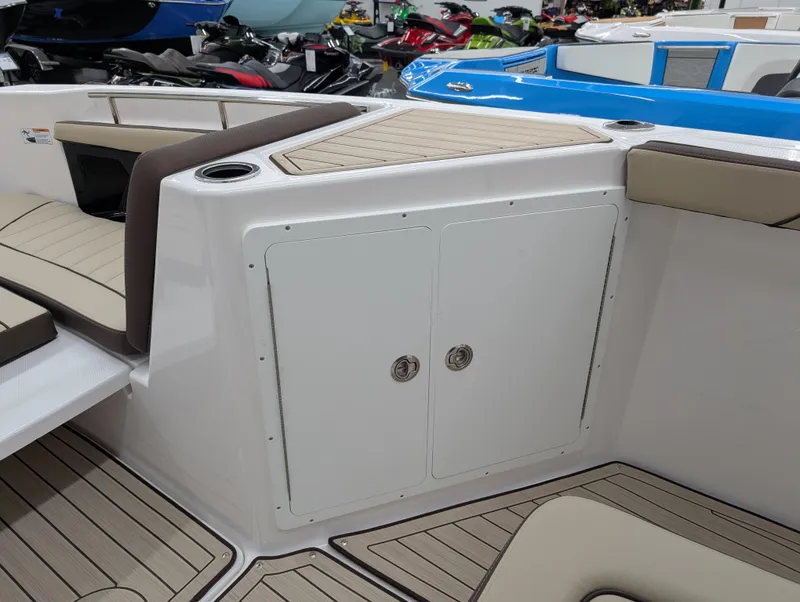 Slide: The Image of 2024 Yamaha Boats 255 FSH Sport H interior with storage compartment and seating. - 18
