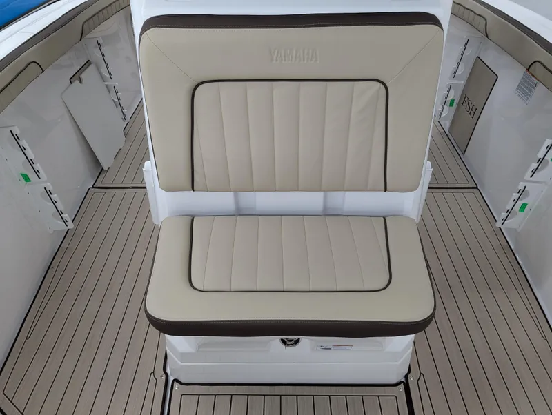 Slide: The Image of 2024 Yamaha Boats 255 FSH Sport H, beige seating, sleek deck design. - 20