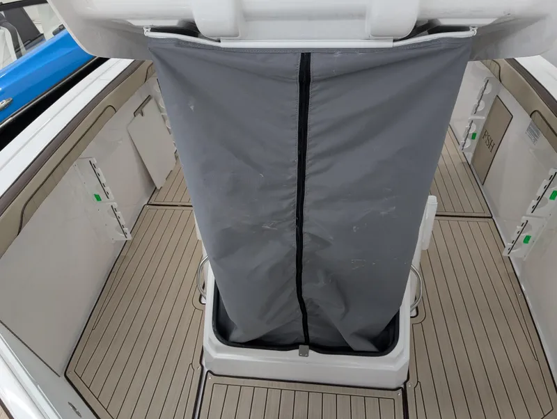 Slide: The Image of 2024 Yamaha Boats 255 FSH Sport H interior with gray cover and sleek deck design. - 21