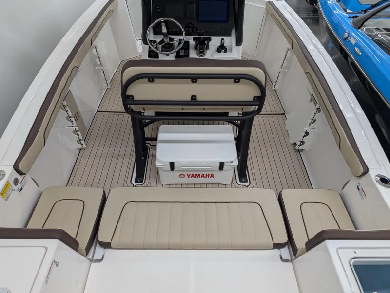 Slide: The Image of 2024 Yamaha Boats 255 FSH Sport H interior with seating and steering console. - 3