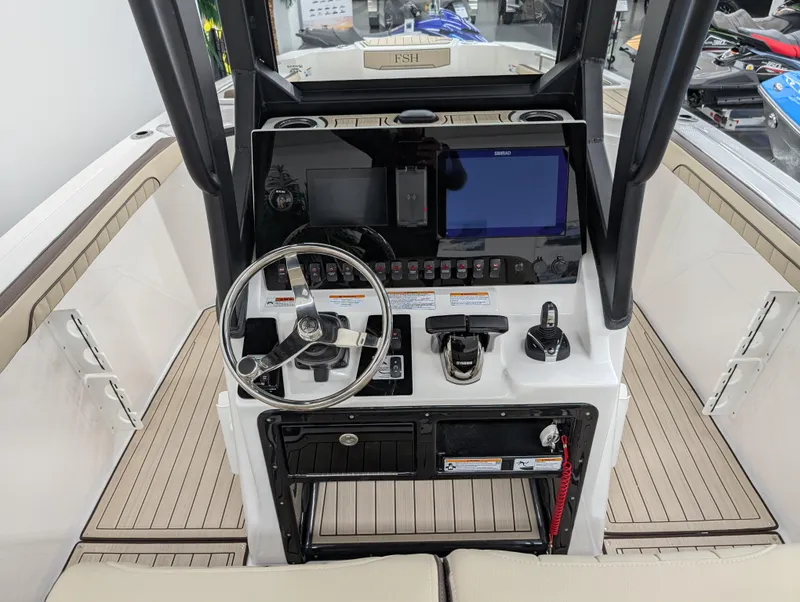 Slide: The Image of 2024 Yamaha Boats 255 FSH Sport H dashboard with steering wheel and controls. - 5