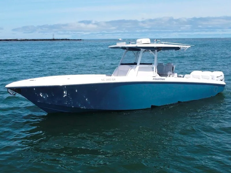 Slide: The Image of 2021 Fountain 34 CC LS boat on open water, showcasing sleek design and modern features. - 1