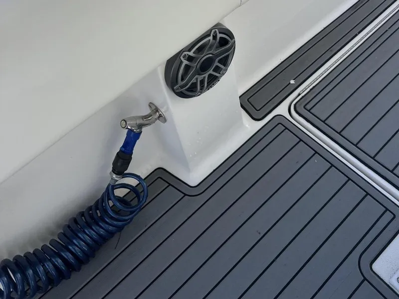 Slide: The Image of Deck of 2021 Fountain 34 CC LS boat with speaker and coiled hose. - 10