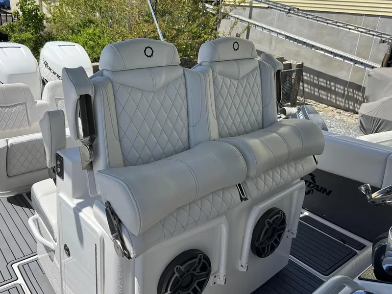 Slide: The Image of 2021 Fountain 34 CC LS boat with luxurious white quilted seating and built-in speakers. - 12