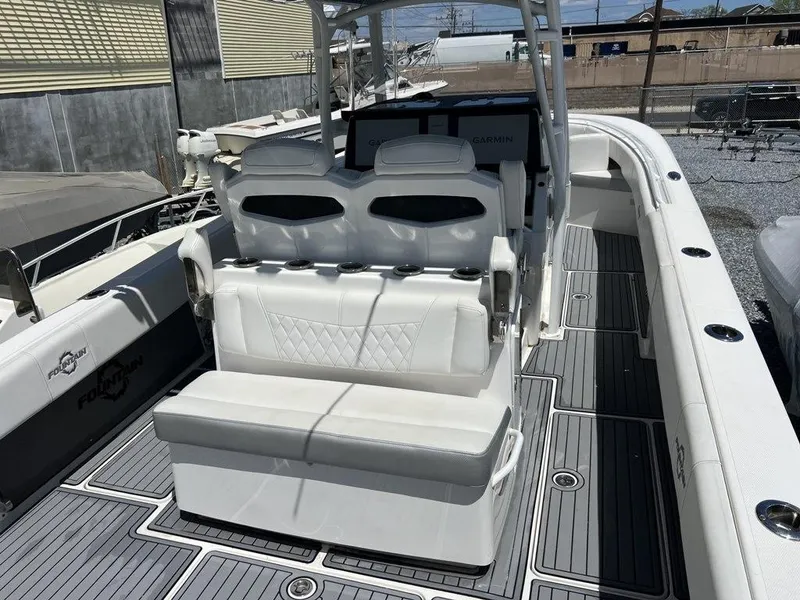 Slide: The Image of 2021 Fountain 34 CC LS boat interior with white seating and modern design. - 16