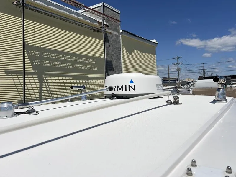 Slide: The Image of 2021 Fountain 34 CC LS boat with Garmin equipment on deck, under clear blue sky. - 17