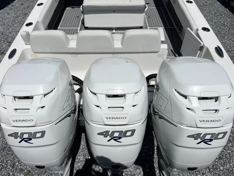 Slide: The Image of 2021 Fountain 34 CC LS boat with triple 400R Verado engines, rear seating view. - 18