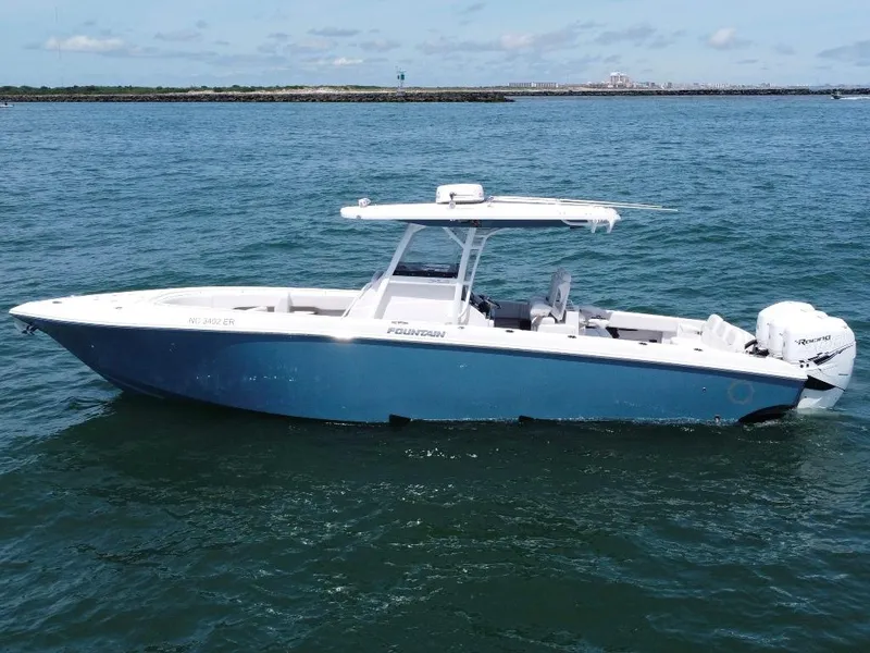 Slide: The Image of 2021 Fountain 34 CC LS boat on open water, side view. - 2