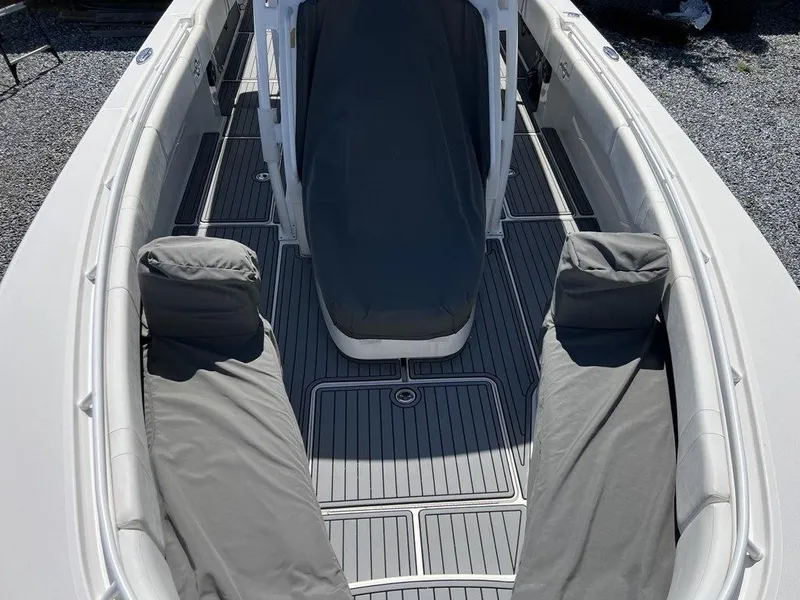 Slide: The Image of 2021 Fountain 34 CC LS boat interior with gray seating and deck. - 20