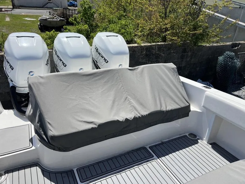 Slide: The Image of 2021 Fountain 34 CC LS boat with triple outboard engines, covered seating area. - 21