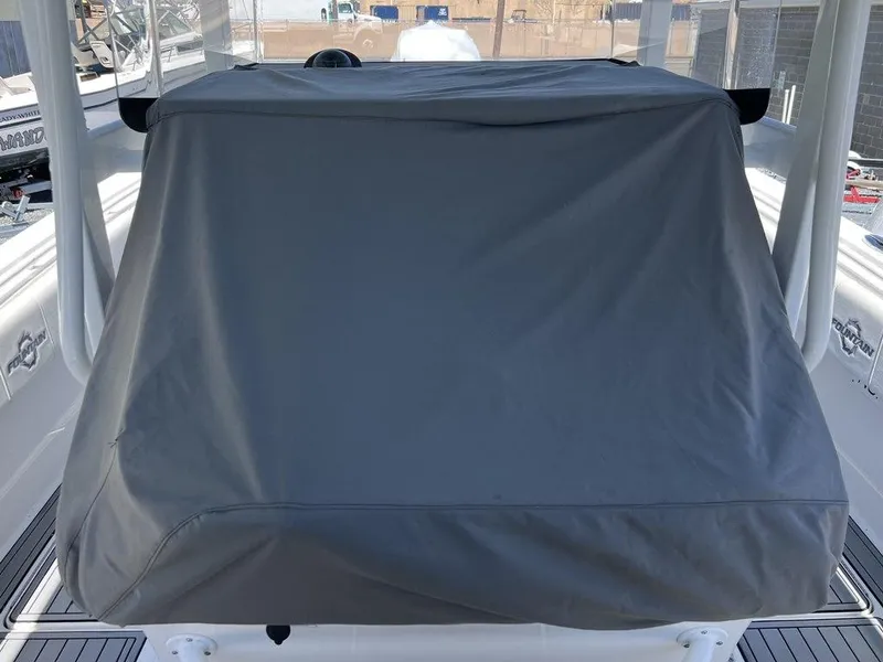 Slide: The Image of 2021 Fountain 34 CC LS boat console covered with a protective gray tarp. - 22