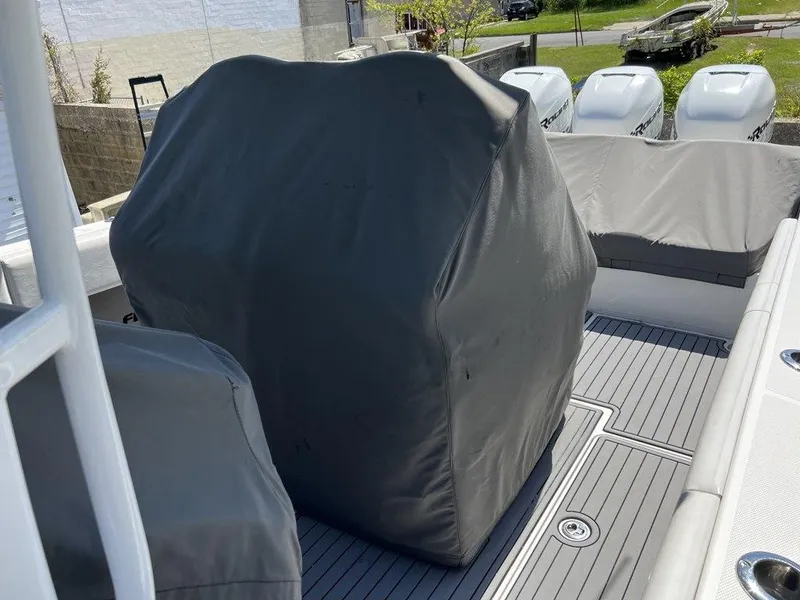 Slide: The Image of 2021 Fountain 34 CC LS boat with covered seating and outboard motors. - 23