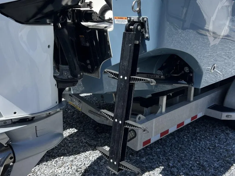 Slide: The Image of 2021 Fountain 34 CC LS boat with a foldable ladder and trailer. - 24