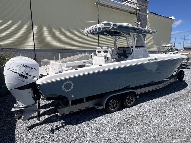 Slide: The Image of 2021 Fountain 34 CC LS boat on trailer, featuring sleek design and powerful engine. - 3