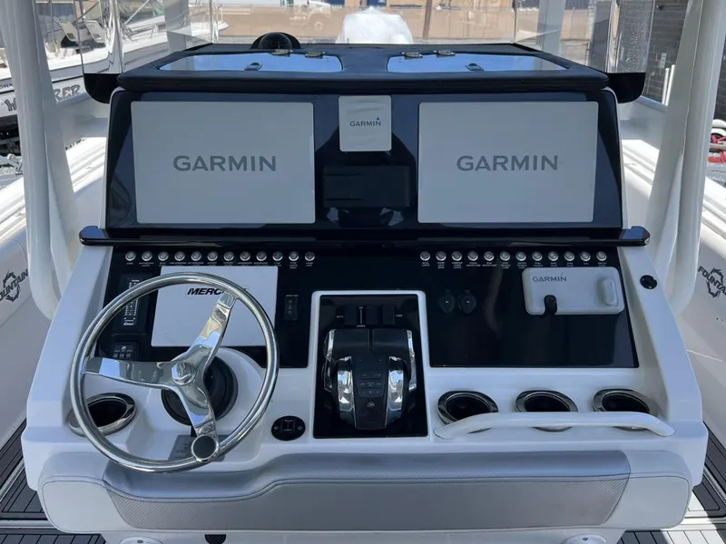 Slide: The Image of 2021 Fountain 34 CC LS boat dashboard with dual Garmin displays and steering wheel. - 4