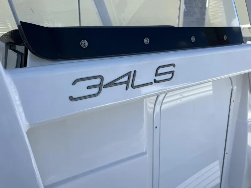 Slide: The Image of 2021 Fountain 34 CC LS boat, close-up of model name on white exterior. - 5