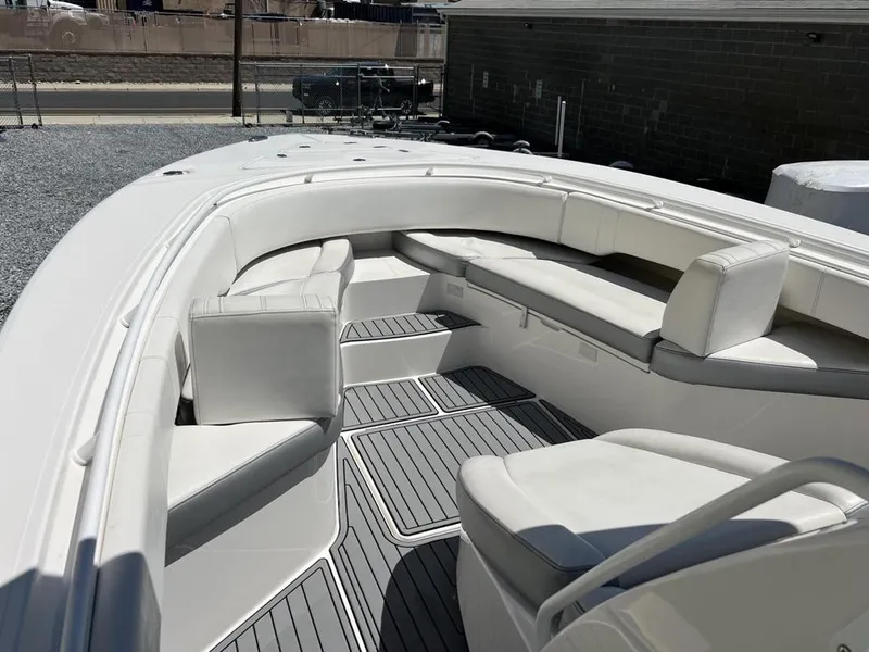 Slide: The Image of 2021 Fountain 34 CC LS boat interior with white seating and gray flooring. - 8