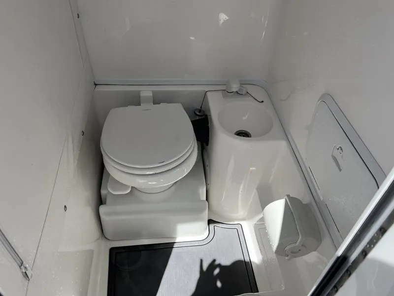 Slide: The Image of Compact bathroom in 2021 Fountain 34 CC LS boat with toilet and sink. - 9