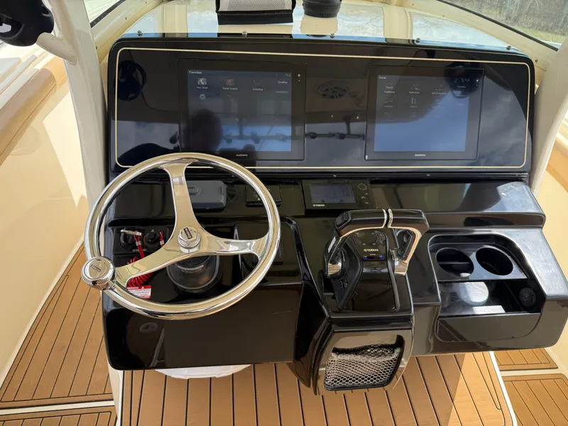 Slide: The Image of Helm of 2016 Scout 300 LXF boat with steering wheel and control panel. - 11