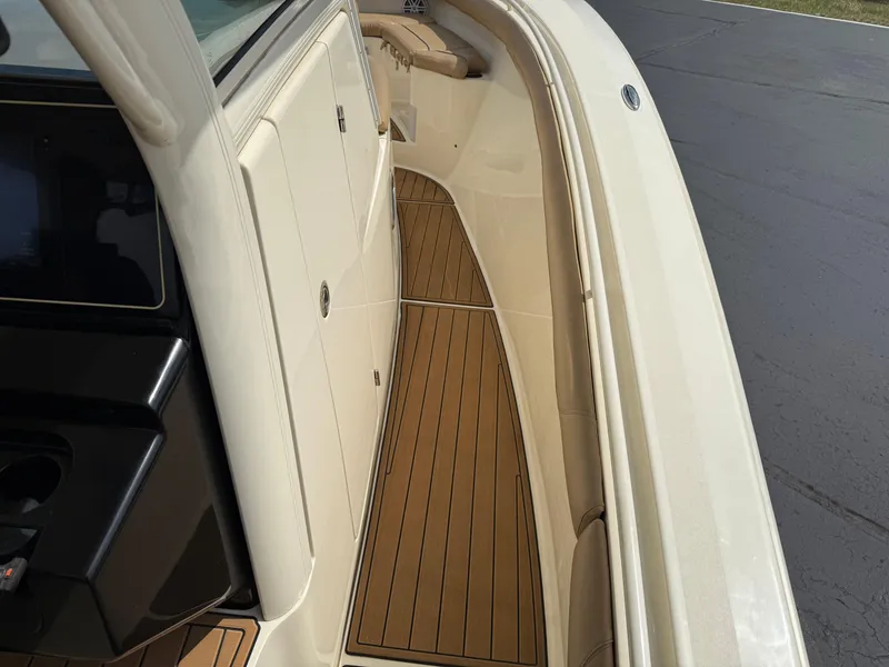 Slide: The Image of 2016 Scout 300 LXF boat deck with sleek design and wood finish. - 14