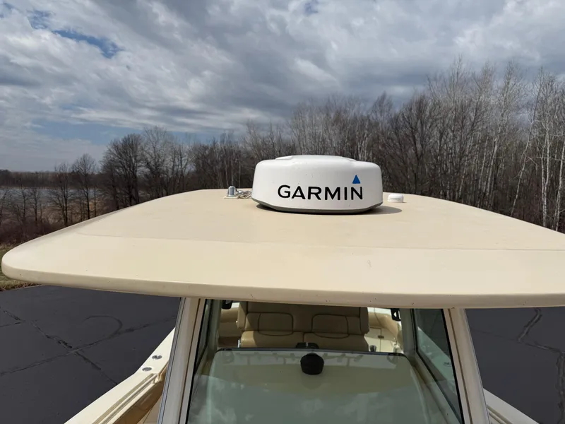 Slide: The Image of 2016 Scout 300 LXF boat with Garmin radar on the roof, under a cloudy sky. - 17